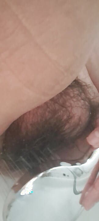 Mature milf washing her hairy pussy