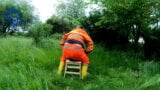 Riding dino toy in garden wearing hivis and rubber boots snapshot 6