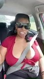Solo ebony Desiree Desire flashes her tits while driving snapshot 3