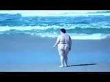 Fat Slut walking on beach snapshot 4