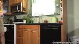 American gilf Justine lowers her panties in the kitchen snapshot 1