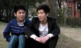 two chinese boys having good time snapshot 2