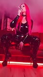 Pink haired Luvie Doll smoking her EVE 120s cigarette like a demon in her pvc catsuit and long fingernails snapshot 1