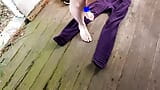 Legs spread on the porch and brush tucked in snapshot 4