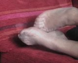 Los pies de nylon de la señora se mueven en el sofá snapshot 6