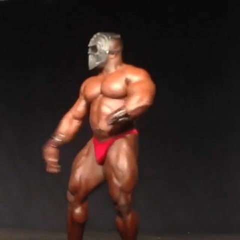 Str8 bodybuilder flexing on stage