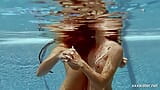 In the indoor pool, two stunning girls swim snapshot 11