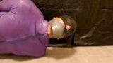 Male bondage. Gagged and hogtied in a purple latex catsuit. Tape gagged with duct tape, blindfolded. Barefoot bondage. snapshot 5