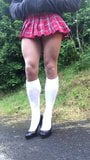 crossdresser schoolgirl posing in public outdoors. snapshot 6