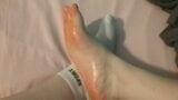 OILING UP MY FOOT IN MY BEDROOM ON MY BED. snapshot 2