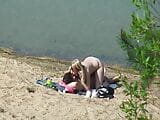 A couple of young nudists are spied on while having sex and snapshot 4