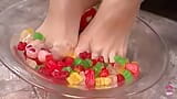 A Kinky Brunette Sticks Her Feet in Gummy Bears and Performs a Footjob Until Cumshot snapshot 1