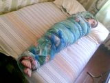 Barefoot girl mummified in a bedsheet snapshot 5