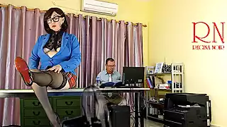 A giant secretary sits on an office desk. The manager guy is very surprised at her height. snapshot 1