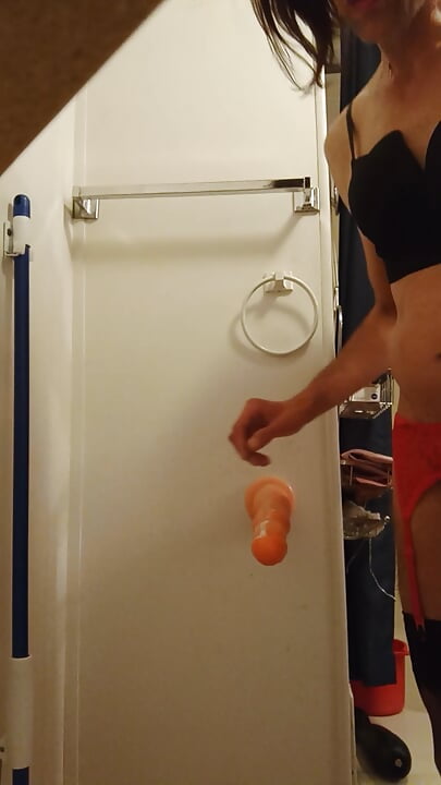 The lady moans and cum shots standing, without hands from the dildo in the ass)