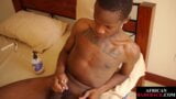 Inked Nubian twink oils up his uncut dick before jerking snapshot 16