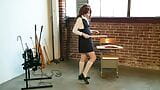 The cheeky schoolgirl is fooling around in the classroom with her percussion instruments. snapshot 4