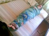 Barefoot girl mummified in a bedsheet snapshot 2