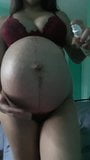 Asian girl oils huge pregnant belly snapshot 1