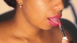 Sexy lips ebony playing with her red lipstick in close up snapshot 16