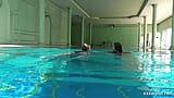 In the indoor pool, two stunning girls swim snapshot 2