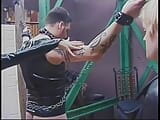 Leather-clad dominatrixes restrain and punish male slave in BDSM chamber snapshot 1