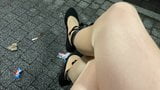 Travestiet poseren buiten in panty bij tramhalte snapshot 5