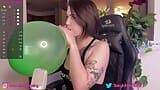 Inflating a big green baloon snapshot 5