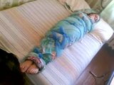 Barefoot girl mummified in a bedsheet snapshot 3