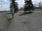 Sissy Ray outdoors on windy day gold dress snapshot 1