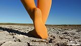 Barefoot walking by dried up lake in yellow pantyhose snapshot 1