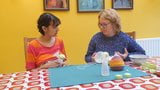 Old woman teaching young woman to pump breast milk snapshot 17