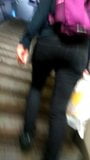 Young woman in tight black pants who goes up the stairs snapshot 2