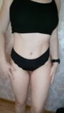 A girl with a perfect figure is trying on different black panties. snapshot 3