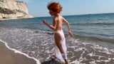 Sexy red-haired girl enjoys a walk by the sea snapshot 5