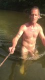 Nudista flaca sumergiéndose en el río snapshot 6