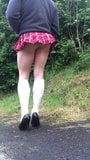 crossdresser schoolgirl posing in public outdoors. snapshot 5