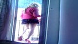 Submissive Lili cd in red heels looks out on the balcony snapshot 1