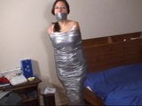 Duct tape mummified girl stands, hops snapshot 6