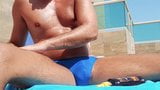 Stud in speedos oiled up and showing his cock by the pool snapshot 2