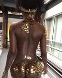 African Girl Wearing Gold Walks snapshot 2