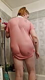 A chubby student girl takes a shower in a pink T-Shirt snapshot 15