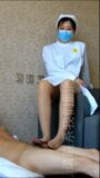 Enfermeira asiática checando os pés snapshot 1