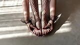 Una chica con medias de rejilla negras acaricia sus piernas snapshot 11