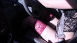 Young girl driving car in red stockings and heels snapshot 12