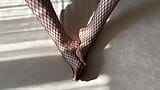 Une fille en collants résille noirs caresse ses jambes snapshot 3