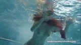 Free watch & Download Redhead Mia stripping underwater