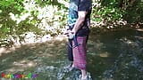 German guy stands in a creek, pisses and jerks off his hard cock snapshot 2