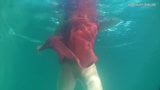 Red dressed mermaid Rusalka swimming in the pool snapshot 5