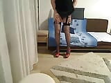 Milf transexual mostrando y tocando frente a la cámara con un vestido de satén negro, medias de red y tacones snapshot 4